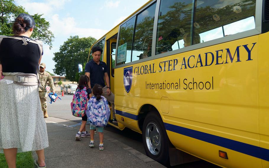 A bus driver greets students heading for Global Step Academy, an international school popular with the community at Yokota Air Base, Japan, July 20, 2023.