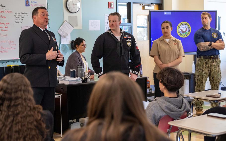 Sailors answer questions from students at Everett High School in Boston on March 20, 2023, during a Navy outreach event. 