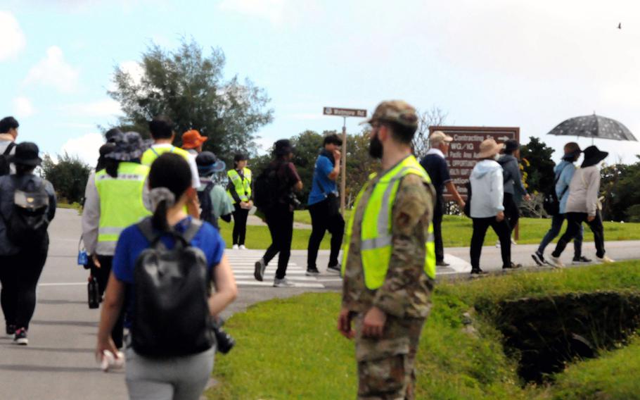 An airman directs mock evacuees during an exercise at Kadena Air Base, Okinawa, Sept. 7, 2024.