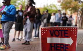 People stand in line during the last day of early voting, Saturday, Nov. 2, 2024, in Charlotte, N.C. (AP Photo/Mike Stewart)