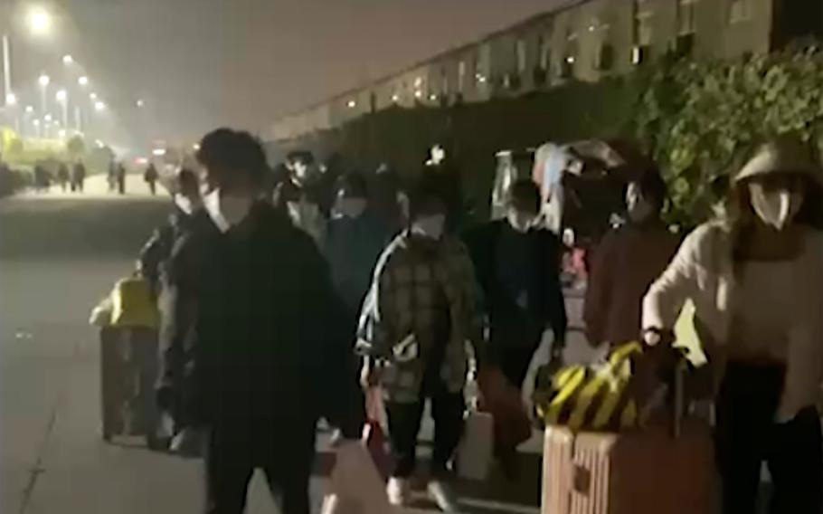 In this photograph  taken from video footage and released by Hangpai Xingyang, radical   with suitcases and bags are seen leaving from a Foxconn compound successful  Zhengzhou successful  cardinal  China’s Henan state  connected  Saturday, Oct. 29, 2022. Workers look  to person  near  the installation  to debar  COVID-19 curbs, with galore  traveling by ft  days aft  an chartless  fig   of mill  workers were quarantined successful  the installation  pursuing  a microorganism  outbreak.