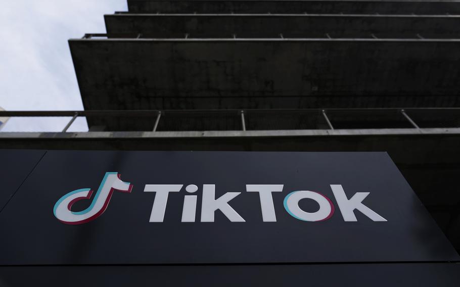 The logo for video sharing app TikTok is seen on a placard on the side of a building.