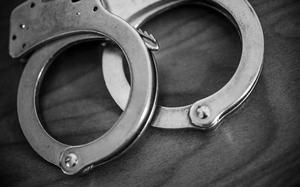 A set of handcuffs sit on a bedside table inside a Muncie, Ind., hotel on Tuesday, Jan. 30, 2018.