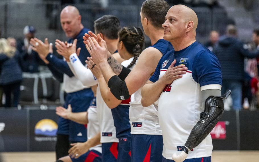 Competitors are introduced onto a volleyball court