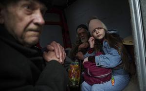 Hanna, 12, and her family sit ride inside a van during an evacuation from Pokrovsk, Ukraine, Saturday, Dec. 21, 2024. (AP Photo/Evgeniy Maloletka)