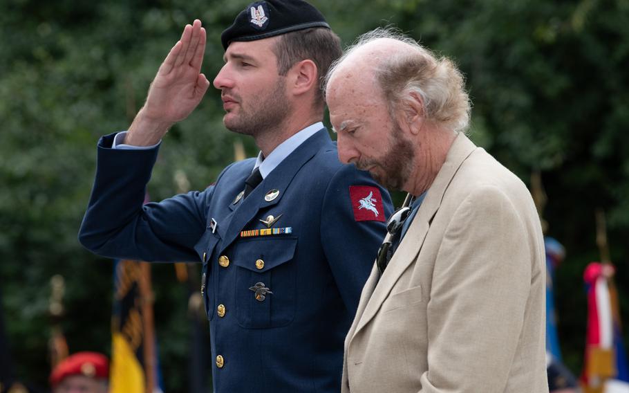 Philip Coppola, right, and a Belgian soldier attend a memorial in Cendron