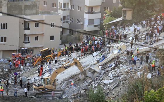 Rescuers sift through the rubble looking for survivors and victimes after an Israeli airstrike in Sidon, Lebanon.