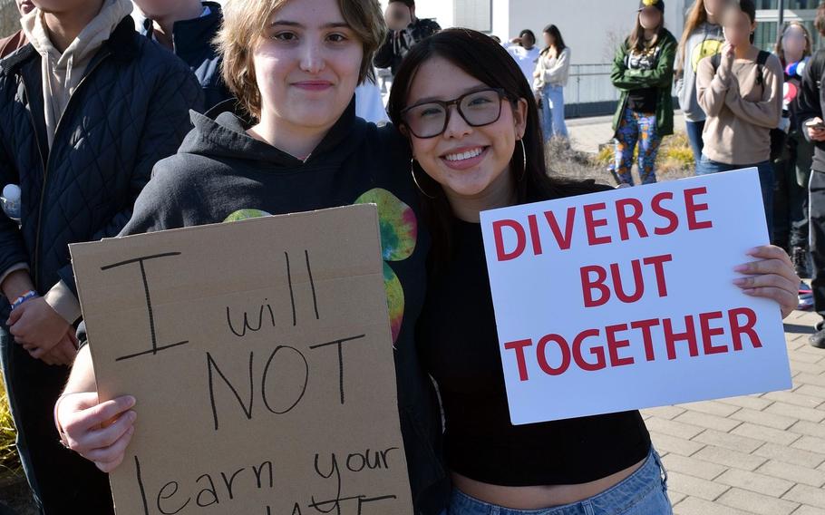 Students hold up protest signs