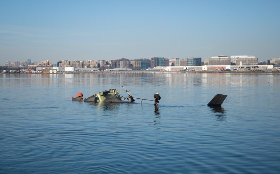 Pieces of a U.S. Army Black Hawk helicopter are seen in the Potomac River.