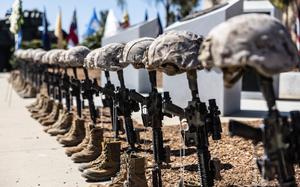 Battlefield crosses representing U.S. Marines from 1st Light Armored Reconnaissance Battalion, 1st Marine Division, who gave their lives during Operation Iraqi Freedom stand in front of a memorial during a 20th anniversary commemoration ceremony the battalion held at Marine Corps Base Camp Pendleton, California, March 18, 2023. The battalion held the ceremony to honor those lost during OIF and to remember the battalion’s successes during the war in Iraq. (U.S. Marine Corps photo by Cpl. Cameron Hermanet)