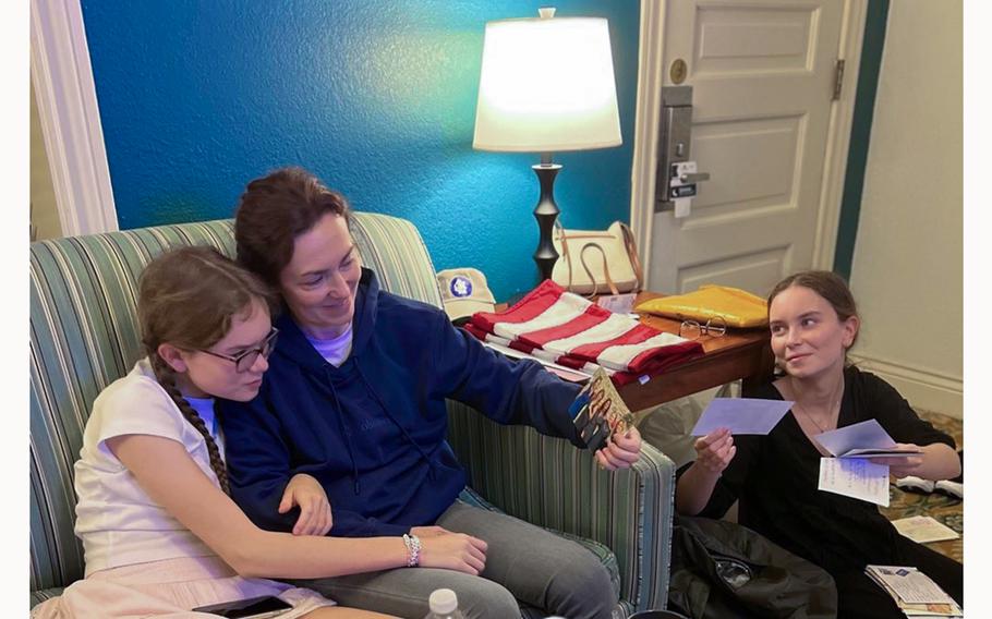 Kurmasheva and her daughters, Miriam Butorin, left, and Bibi Butorin, open letters and postcards that well-wishers sent her while she was imprisoned in Russia. 