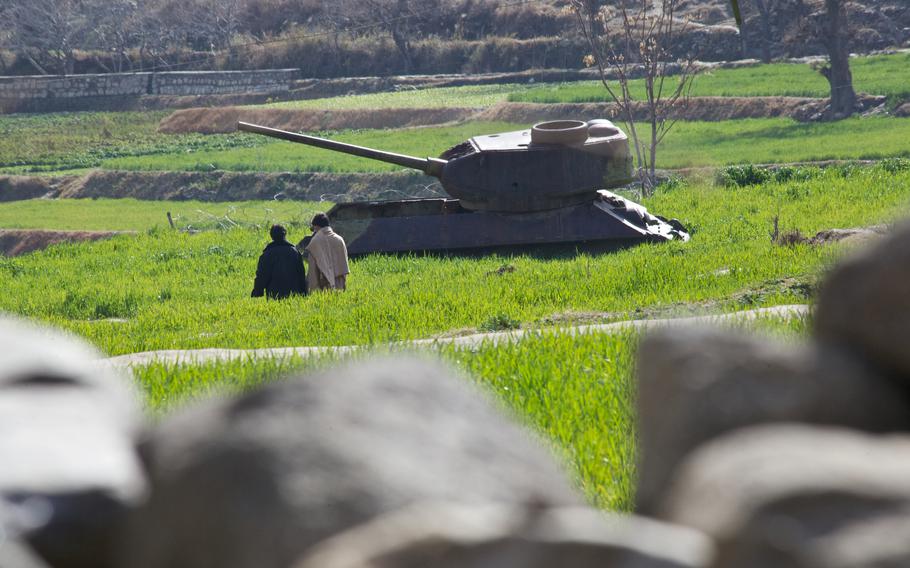 A stripped Soviet tank outside the Shegal district center