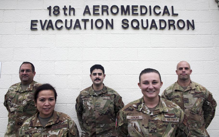 A team of aeromedical professionals was recognized recently by the 18th Wing at Kadena Air Base, Okinawa, for providing emergency care to a passenger suffering from decompression sickness on a flight in Japan.