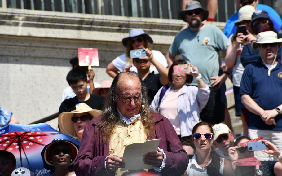 A reenactor portraying Benjamin Franklin reads the Declaration of Independence from the steps of the National Archives on July 4, 2024.