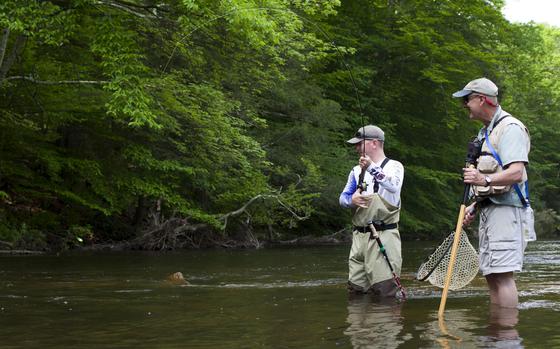 U.S. Marine Corps Staff Sgt. Bradley Wells, left, with Special Purpose Marine Air-Ground Task Force Fleet Week New York, reels in a trout with Rick Alampi, a volunteer guide, during a fly fishing event hosted by Project Healing Waters in Long Valley, New Jersey, May 26, 2018. The service members attended the fly fishing event as part of Fleet Week New York, which was hosted to give Marines, Sailors and Coast Guardsmen the opportunity to interact with the public, demonstrate capabilities, and teach the people of New York about America’s sea services. (U.S. Marine Corps photo by Sgt. Bethanie C. Sahms)