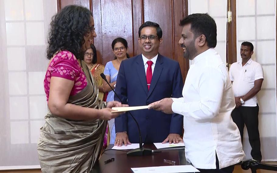 Lawmaker Harini Amarasuriya, 54, left, takes oath for Prime Minister