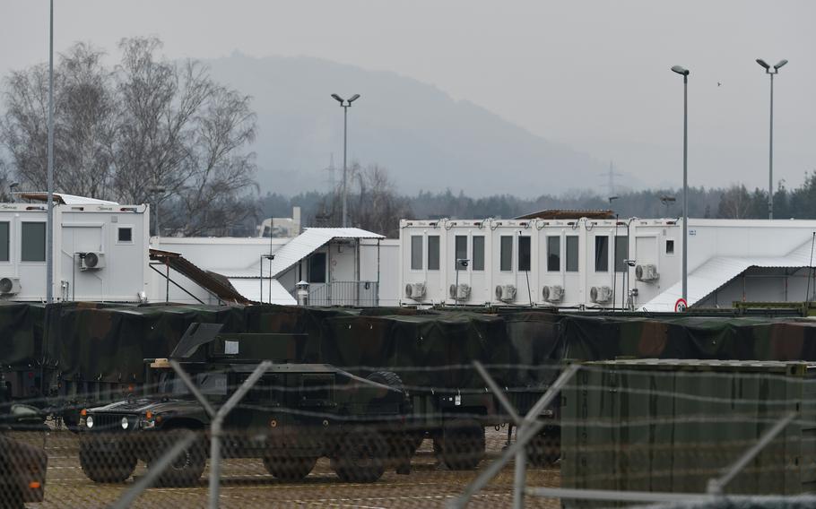 Military vehicles are parked in front of housing units at a U.S. miltary base in Germany.