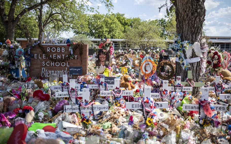 A memorial of flowers and other tribute items arrayed outside Robb Elementary after a gunman killed 19 students and two teachers at the Uvalde, Tex., school in 2022.