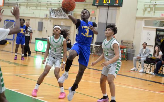 Yokota's Kysiem Banks shoots past Kubasaki's Maurice Brown and Noah Alonso.