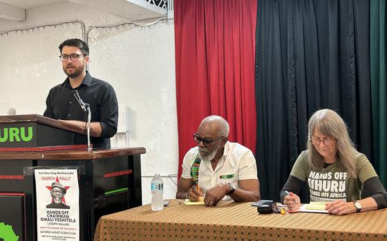 Jesse Nevel, left, speaks during a news conference at the Uhuru House in St. Petersburg, Florida, as Omali Yeshitela, middle, and Penny Hess listen. The three members of the Uhuru Movement face trial on federal charges alleging that they acted for years as agents of the Russian government in an effort to sow political discord in the U.S. (Dan Sullivan/Tampa Bay Times/TNS)