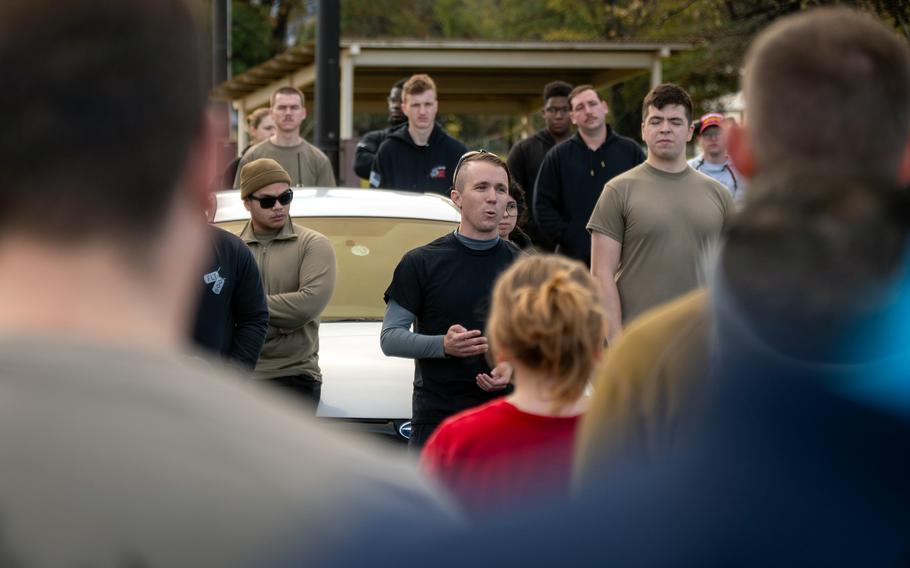 Participants listen to a man in running attire speak before taking part in a 5K race.