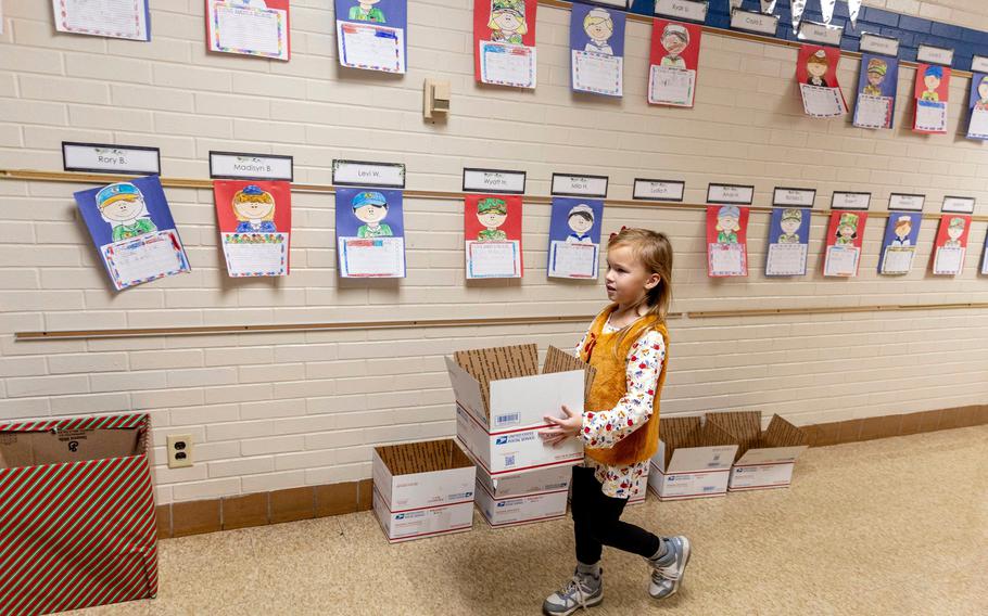 First and second grade students help fill bags of donated Halloween candy 