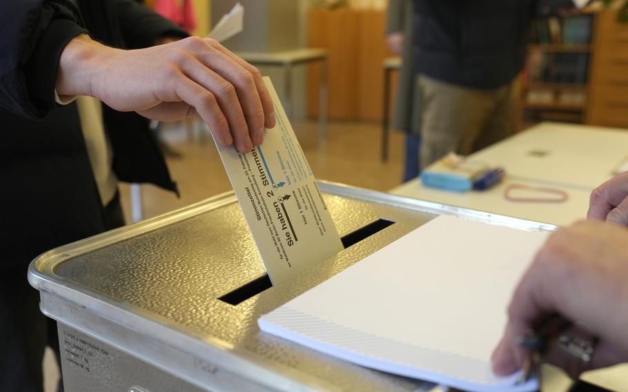 A resident casts a vote at a polling station in Berlin, Germany, Sunday, Feb. 23, 2025, during the German national election.