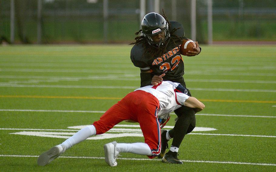 International School of Brussels defensive back Ezra Clayborne tackles Spangdahlem quarterback Messiah Smith during a game on September 21, 2024 at Spangdahlem High School in Spangdahlem, Germany.