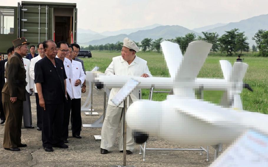 North Korean leader Kim Jong Un inspects drones at an undisclosed location in this doctored image released by the state-run Korean Central News Agency, August 26, 2024.