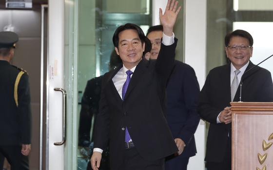 Taiwanese President Lai Ching-te waves to the media.