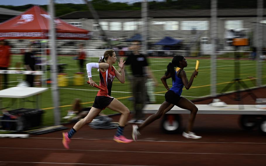 Makiah Parker leads ahead of Kaiserslautern’s Katharina Storch during the girls 4x400 meter relay finals at the 2024 DODEA European Championships at Kaiserslautern High School in Kaiserslautern, Germany, on May 24, 2024. Wiesbaden triumphed over Kaiserslautern with a time of 4:06.72 to 4:16.29.