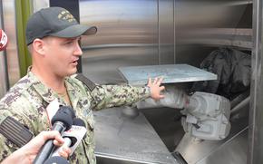 Marine Corps Lt. Joel Hunter shows reporters a 3D printer being used in the Rim of the Pacific exercise to manufacture metal parts during a demonstration at Marine Corps Base Hawaii on July 2, 2024.