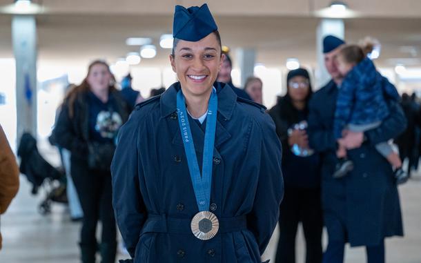 Airman Anita Alvarez poses for a photo with her 2024 Paris Olympics silver medal after Basic Military Training graduation at Joint Base San Antonio-Lackland, Texas, January 9, 2024. Alvarez is a three-time olympian who will be joining the Department of the Air Force World Class Athlete Program as the first recruited Olympic medalist in the programs history. (U.S. Air Force photo by Kate Anderson)