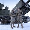 Army Sgt. Makayla Sodergren, a crew chief, and Sgt. Johnathan Welch, a gunner, both with 1st Battalion, 6th Field Artillery Regiment, show off their Multiple Launch Rocket System during exercise Dynamic Front in Rovajavri, Finland on Nov. 20, 2024.