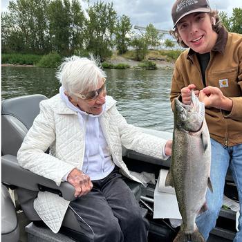 Centenarian Betsy Jeffords is amazed at her catch, skillfully netted for her by 16-year-old Mason Waddle of Longview, Wash.