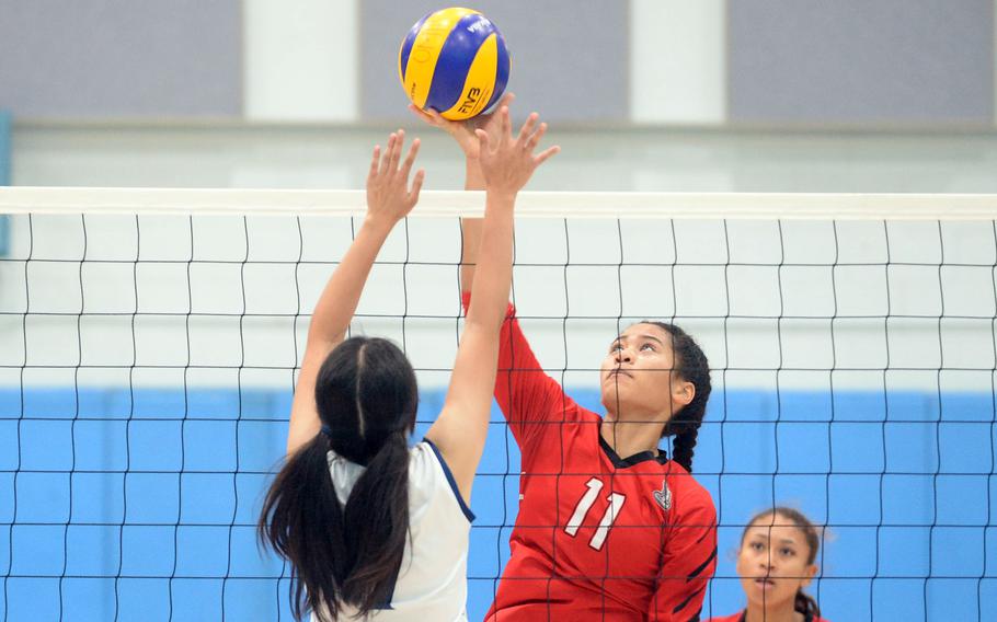 E.J. King and Osan play girls volleyball.