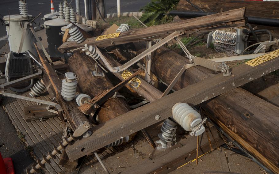 Fallen utilities poles outside of a gas station on Lahainaluna Road in Lahaina, Hawaii, on Aug. 21.