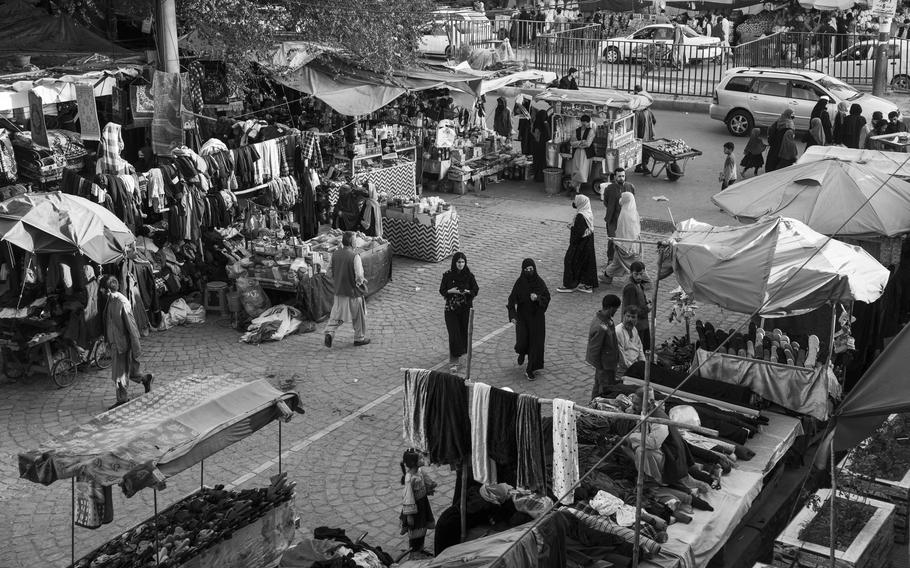 People shop at an open-air market in Kabul earlier this month. 