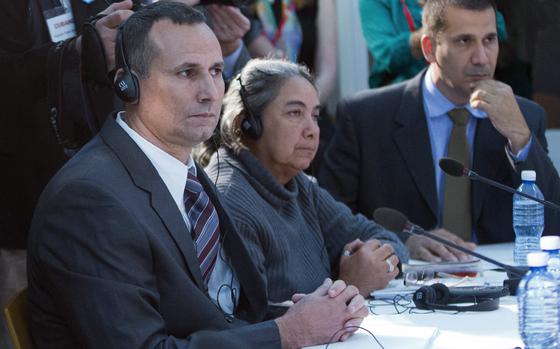 FILE - Cuban dissident Jose Daniel Ferrer, left, sits with Cuban LGBT activist Juana Mora Cedeno, center, and Cuban political activist Antonio Rodiles, right, during a meeting with President Barack Obama at the U.S. embassy in Havana, Cuba, March 22, 2016. (AP Photo/Pablo Martinez Monsivais, File)