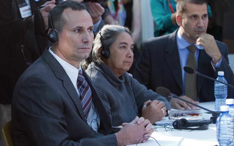 Cuban dissident Jose Daniel Ferrer, left, sits with Cuban LGBT activist Juana Mora Cedeno, center, and Cuban political activist Antonio Rodiles, right, during a meeting with President Barack Obama at the U.S. embassy in Havana, Cuba, March 22, 2016. 