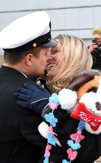 A sailor embraces his loved one with a kiss