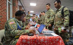 Combined Arms Support Command Soldiers process Advanced Individual Training Soldiers ensuring they have their leave orders, airline tickets and other necessary documents during the Holiday Block Leave program Dec. 18, 2024, at the Richmond International Airport, Virginia. HBL is an annual event that CASCOM conducts to ensure the safe movement of approximately 8,000 AIT Soldiers starting leave over the holidays.