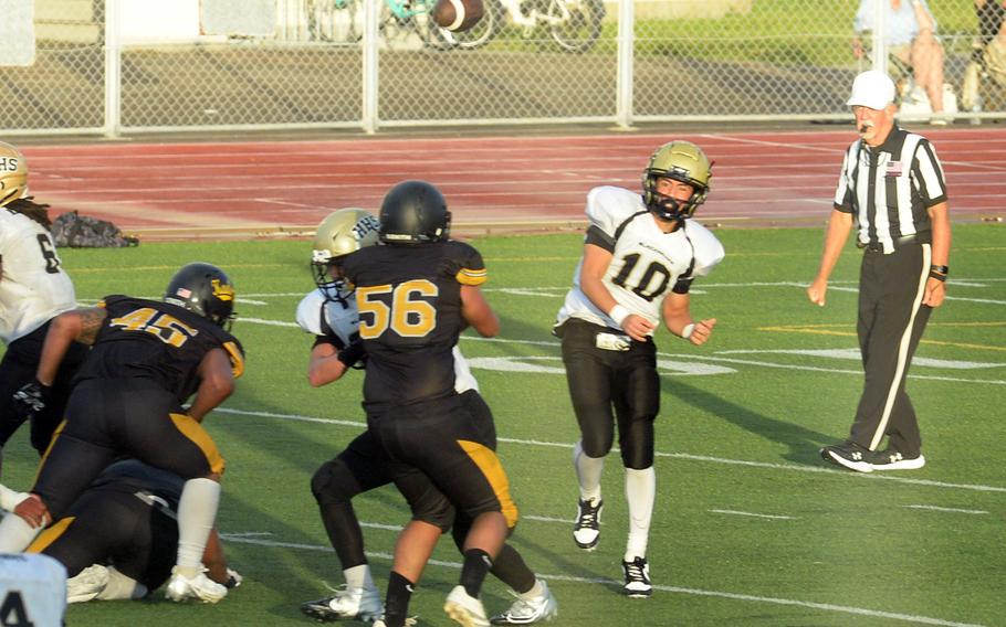 Humphreys quarterback Bradley Miller launches a pass against Kadena. He was intercepted three times by Javier Williams.