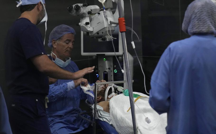 Elias Jaradeh, a legislator and an ophthalmologist, center, who has conducted dozens of operation for victims of this week's attack in Lebanon, performs an eye surgery operation for a man who was injured in the explosion of one of the handheld devices at the Eye Specialist hospital, in Beirut, Lebanon, Friday, Sept. 20, 2024.