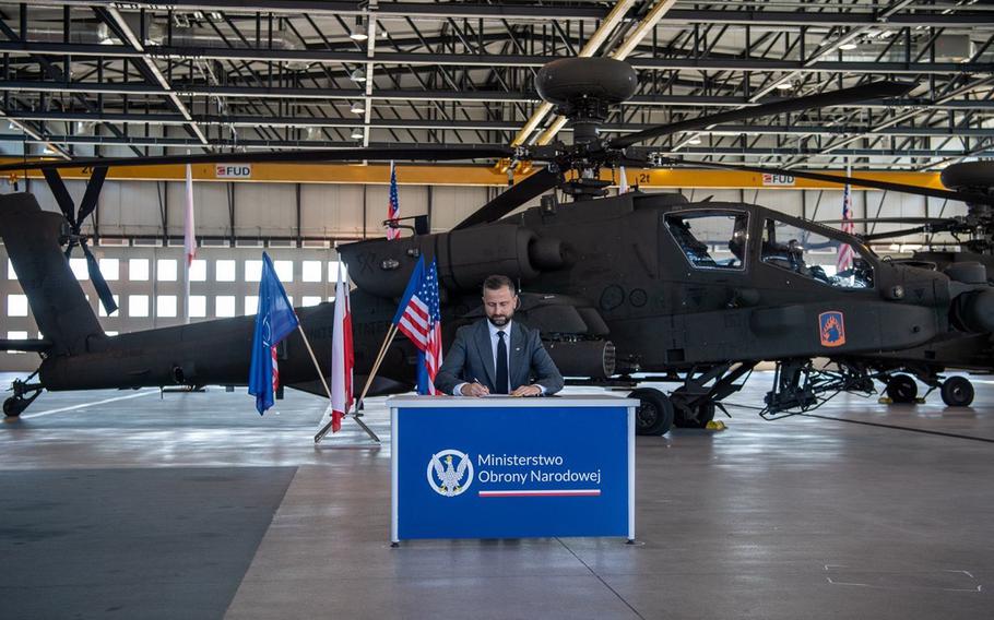 Wladyslaw Kosiniak-Kamysz, Poland's defense minister, signs an agreement to purchase 96 Apache attack helicopters during a ceremony in Inowroclaw, Poland, on Aug. 13, 2024.