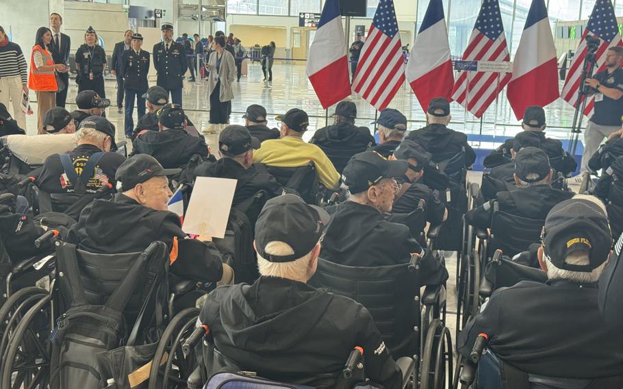 Veterans awaiting welcoming ceremony at Charles de Gaulle airport .