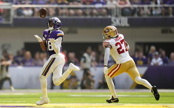 Minnesota Vikings wide receiver Justin Jefferson (18) catches a 97-yard touchdown pass over San Francisco 49ers safety Ji'Ayir Brown (27) during the first half of an NFL football game, Sunday, Sept. 15, 2024, in Minneapolis. (AP Photo/Abbie Parr)