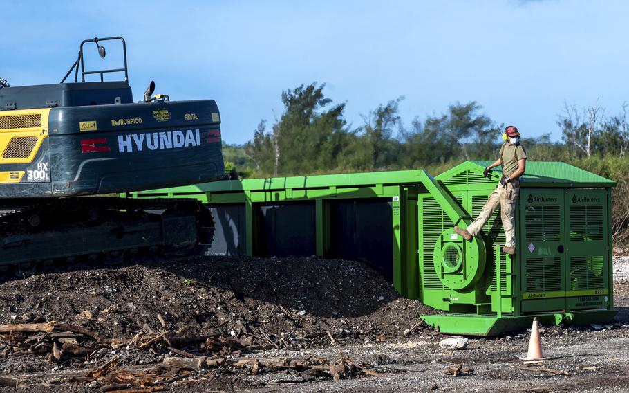 An airman works with an incinerator.