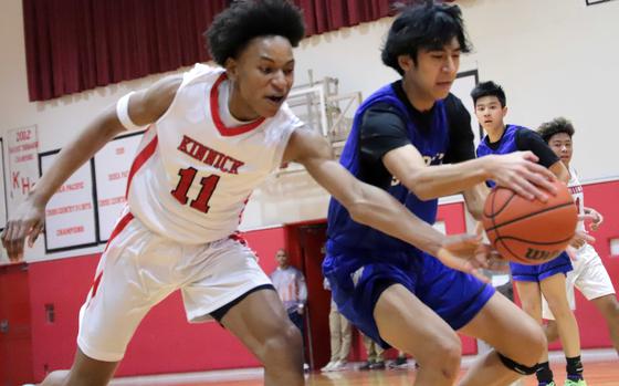 Kinnick's Isaiah Kimbrough tries to slap the ball away from St. Mary's Towa Miyoshi.