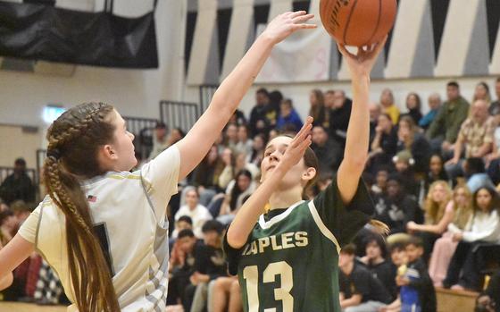 Naples' Chloe Williams gets up a shot before Vicenza's Gracie Perry can get to her Friday, Jan. 31, 2025, in the Cougars' 52-31 victory over the Wildcats in Vicenza, Italy.